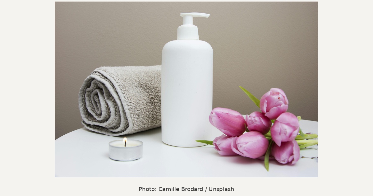 Unbranded white dispenser, towel and pink tulips, skincare gift illustration