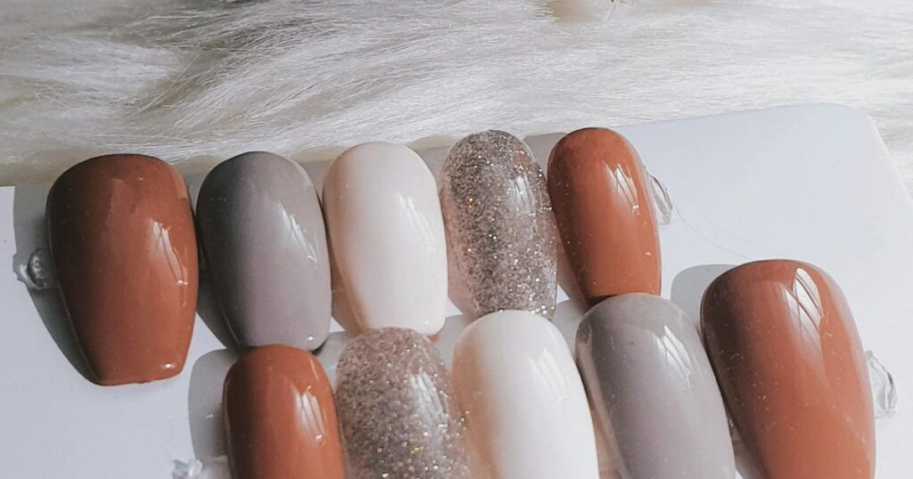 Neutral nude press-on nail polish shades in cream, taupe and caramel