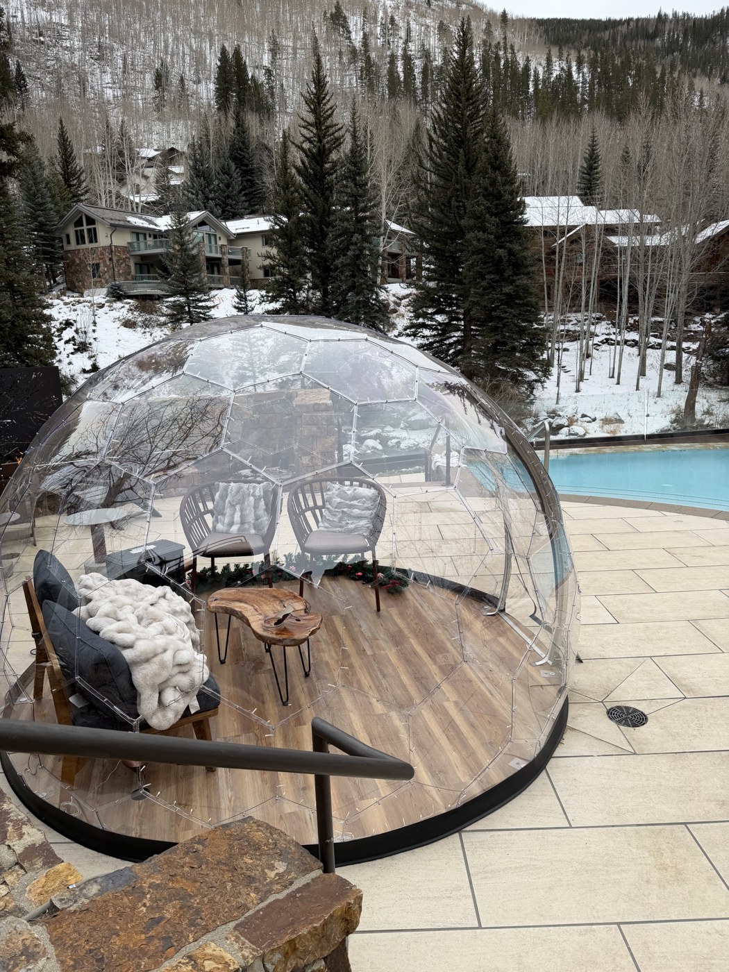 Snowy mountain view and an empty poolside dome in Vail
