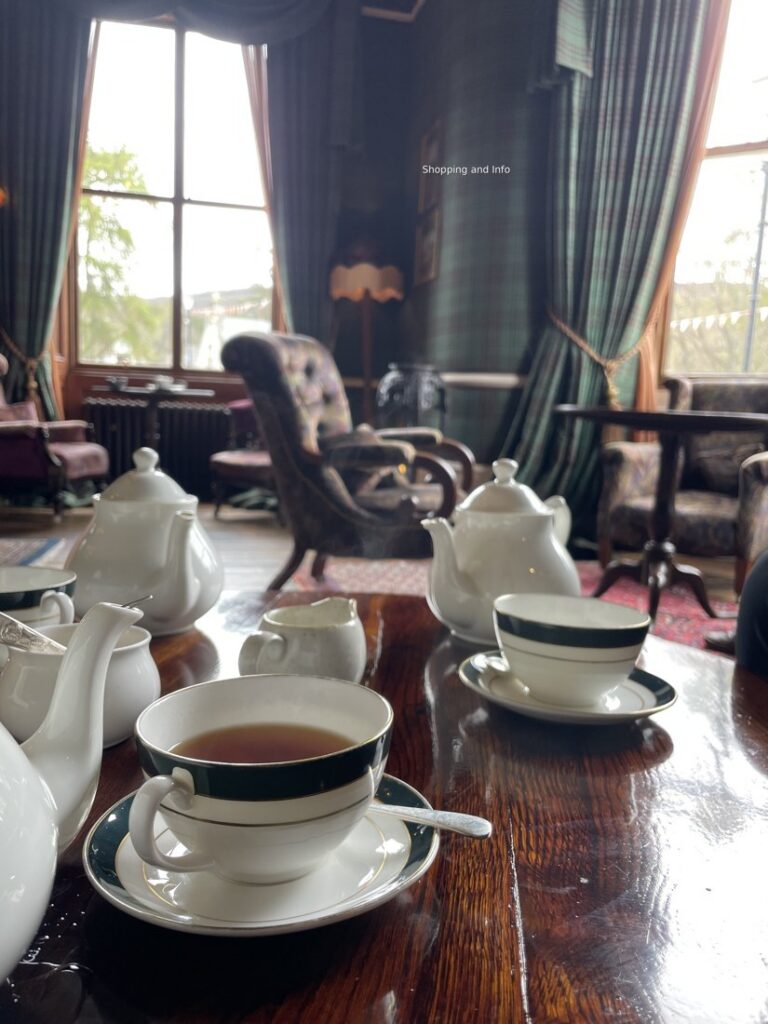 Afternoon tea in a grand hotel lounge, tartan walls and fine bone china
