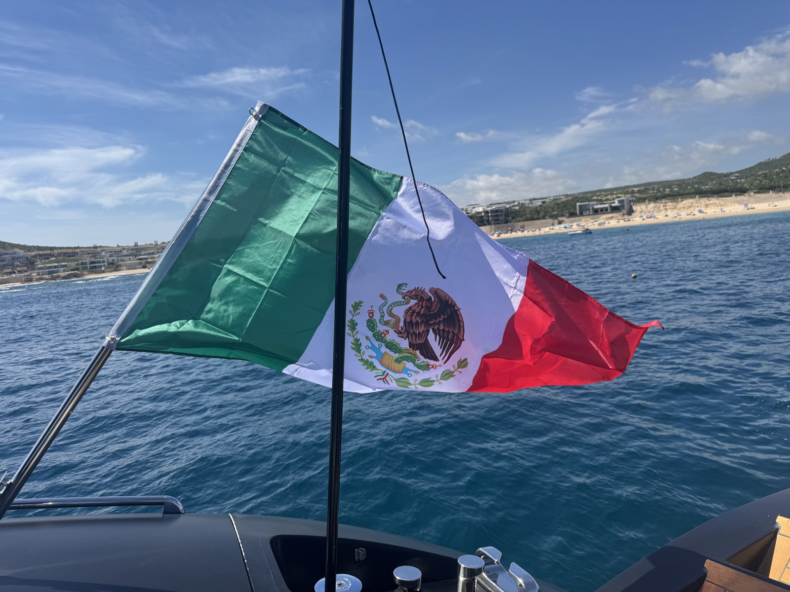 Mexican flag flying over the water in Cabo