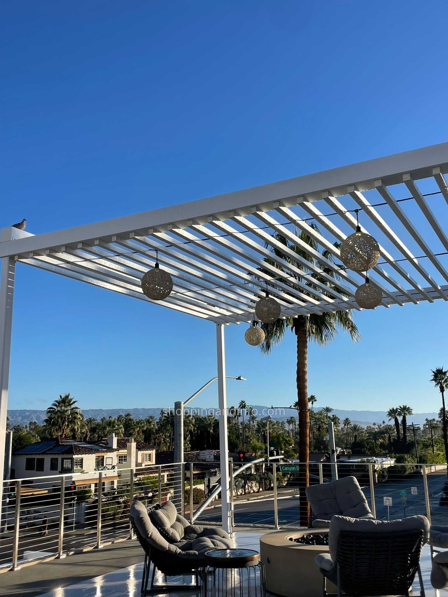 Sunny Palm Springs rooftop seating with mountain views
