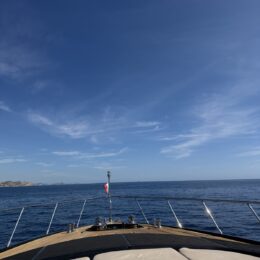 Cabo boat bow and blue water - yacht club cocktail attire