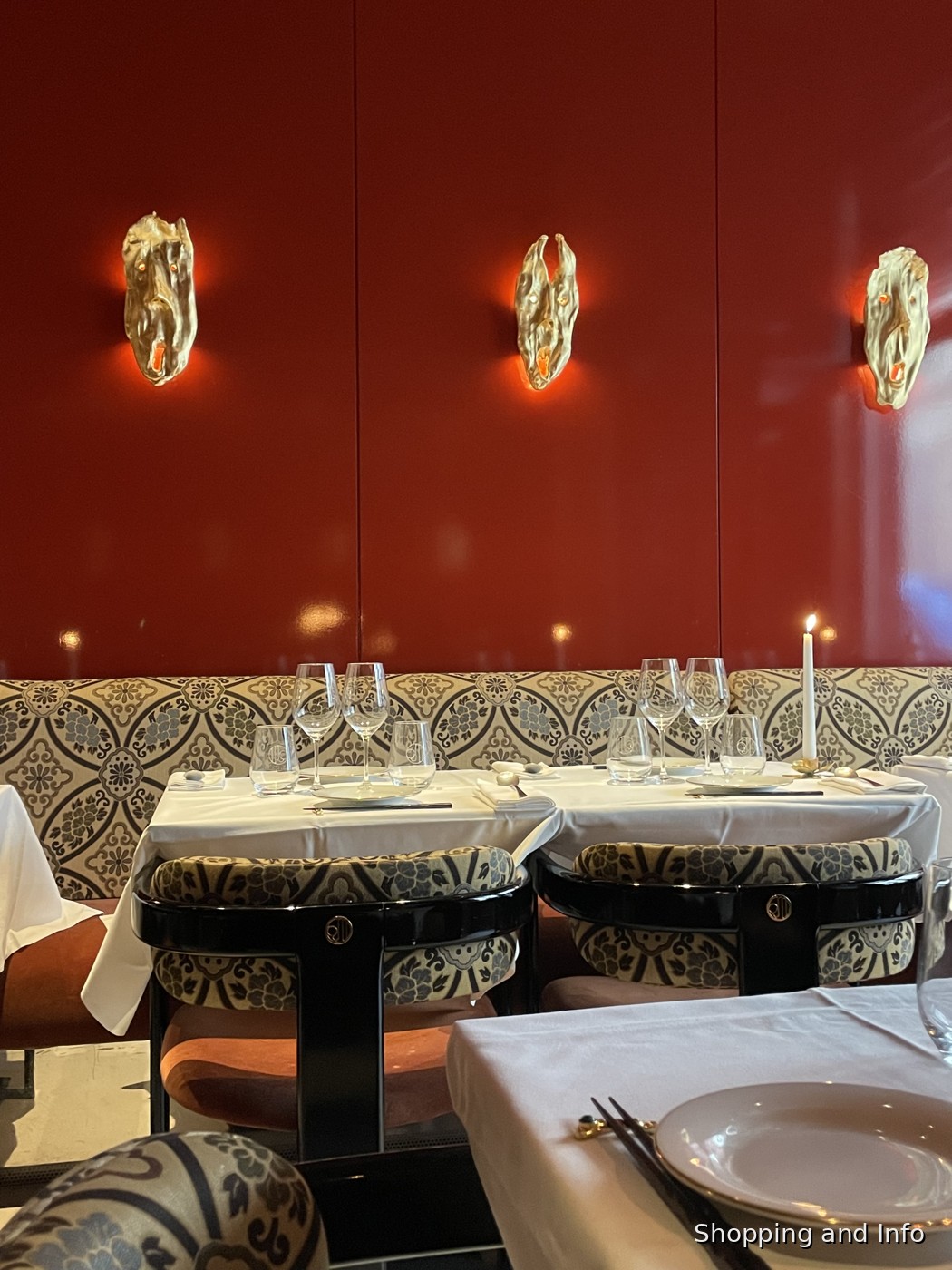 Paris restaurant interior with red lacquer wall and white tablecloths