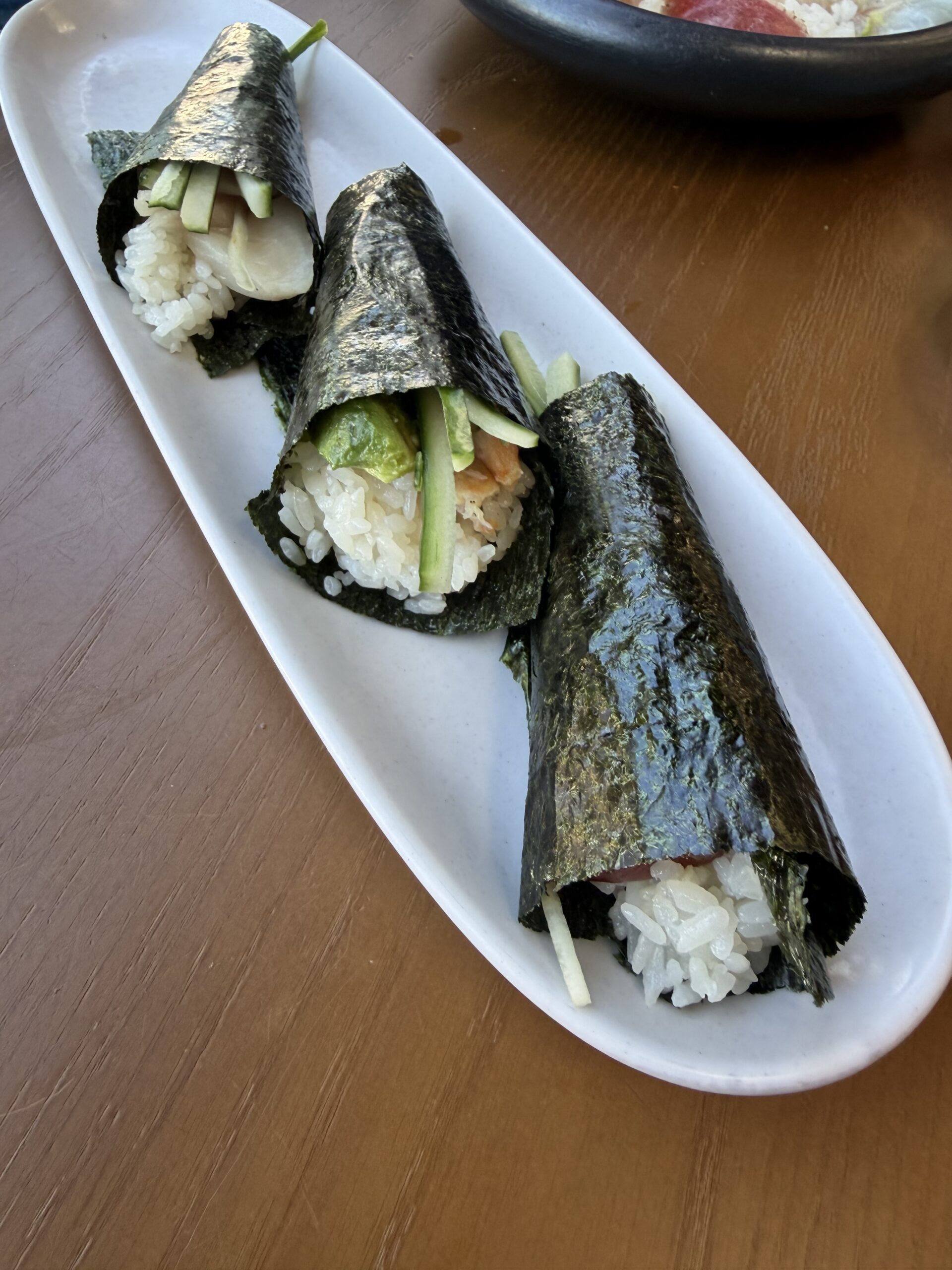 Three hand rolls on a white plate