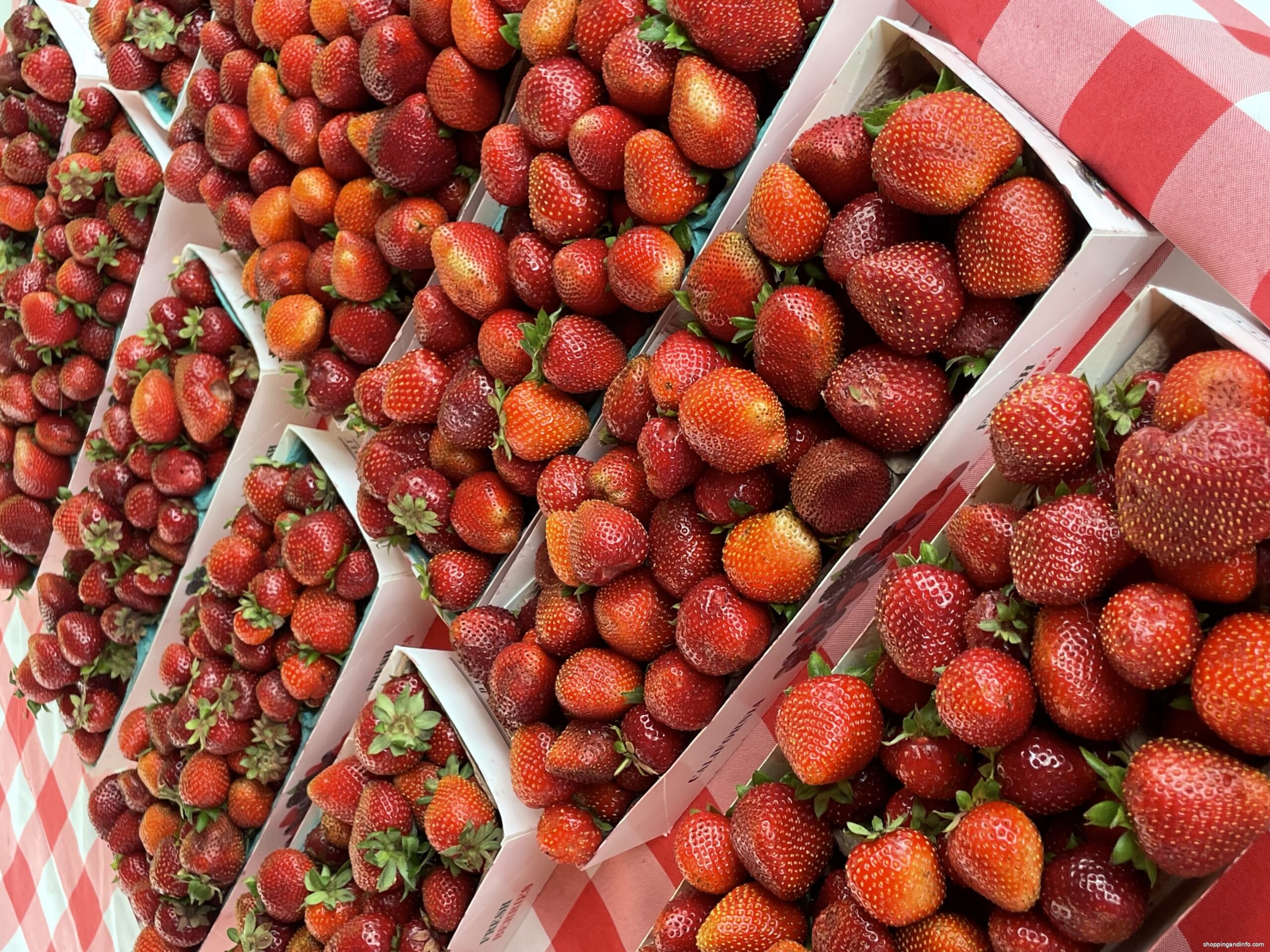 Strawberry cartons stacked in crates at the Laguna Beach farmers market