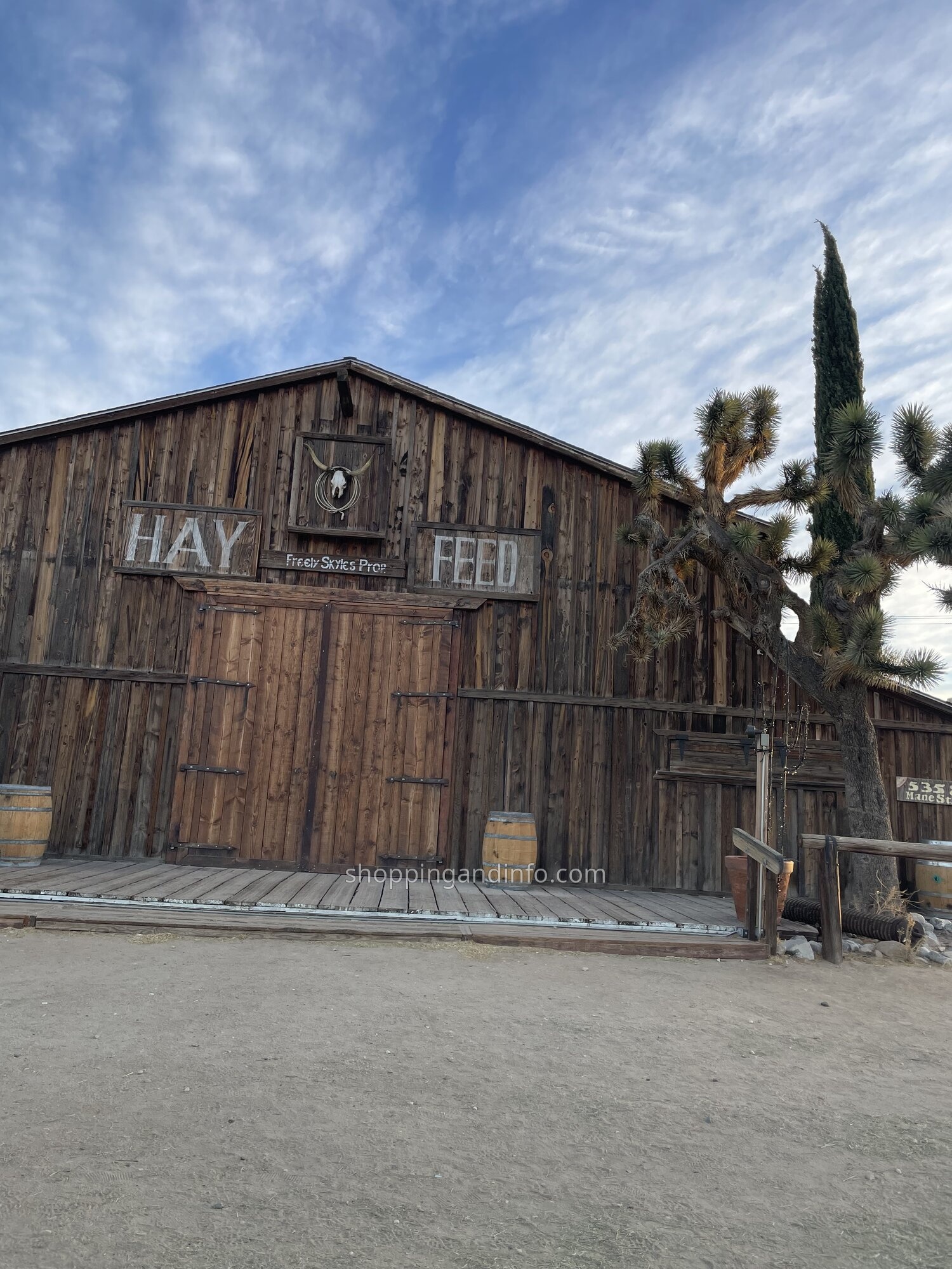 The wooden Hay and Feed barn in Pioneertown beneath a blue desert sky