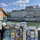 Low-profile sneakers with trousers inspiration: bookstalls beside the Seine in Paris, photographed by Shopping and Info