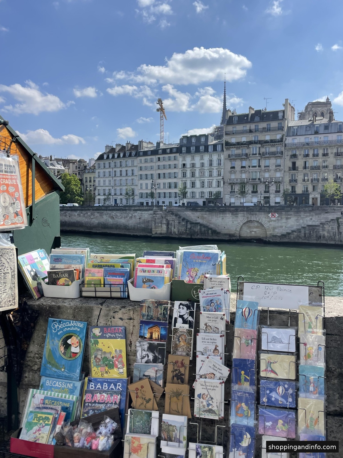 Low-profile sneakers with trousers inspiration: Paris Seine bookstalls photographed by Shopping and Info
