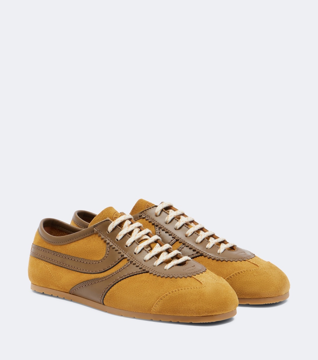 Low-profile sneakers with trousers: Dries Van Noten leather-trimmed suede sneakers in Ocra