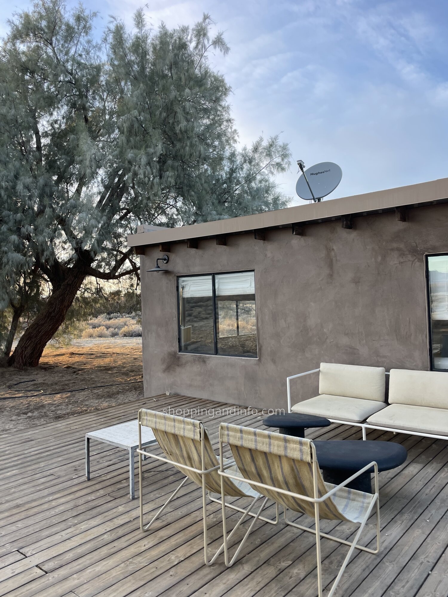 Outdoor chairs and a sofa on the wooden deck at our desert rental