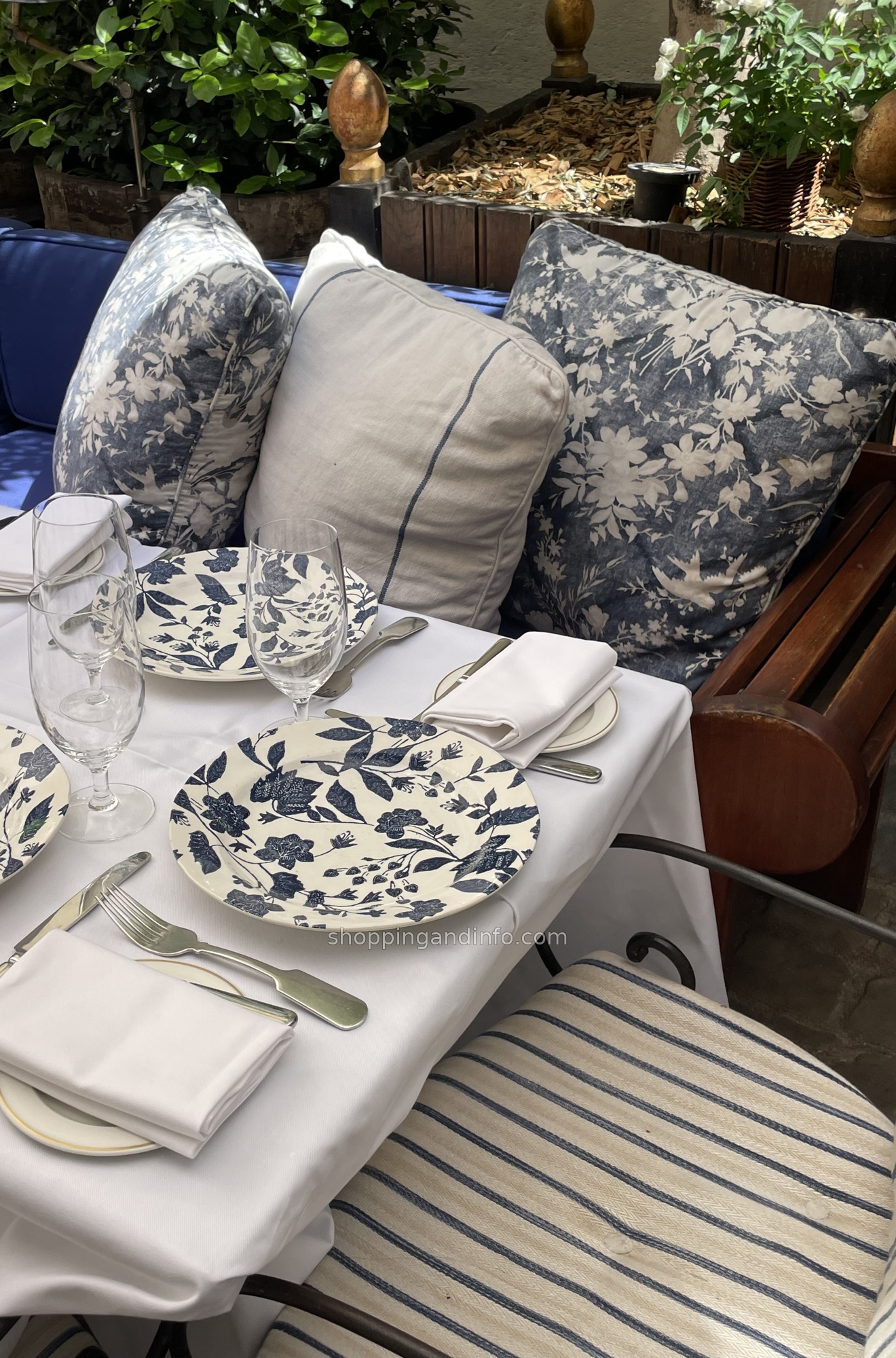 Blue-and-white china and cushions at Ralph's Paris courtyard table