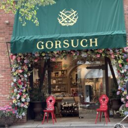 The Gorsuch storefront in Aspen with green awning and flowers