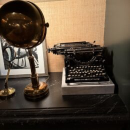 Monica Dutton outfits inspiration, vintage typewriter and brass lamp at Hotel Jerome Aspen