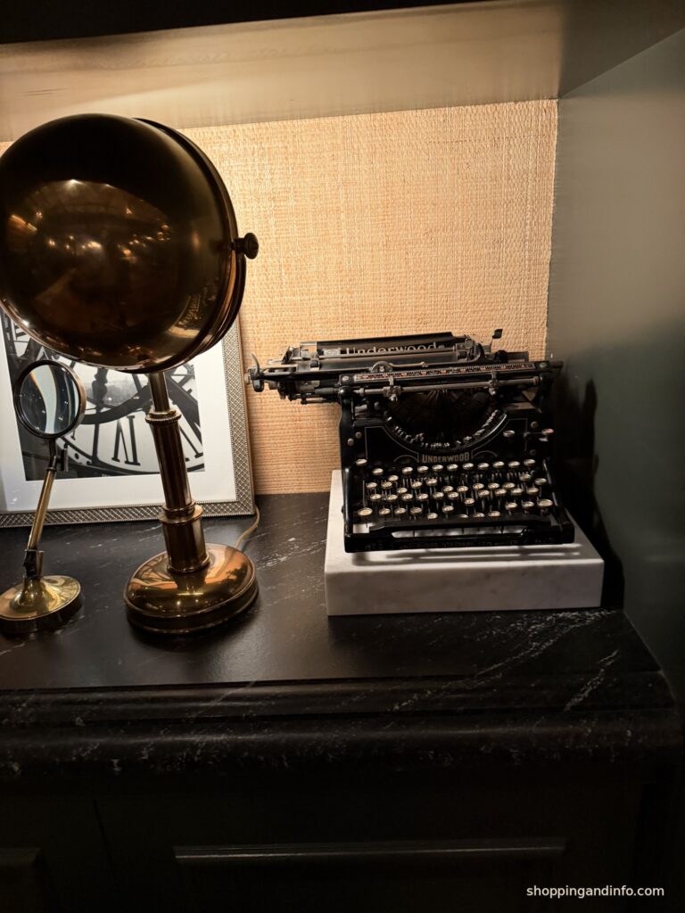 Monica Dutton outfits inspiration, vintage typewriter and brass lamp at Hotel Jerome Aspen