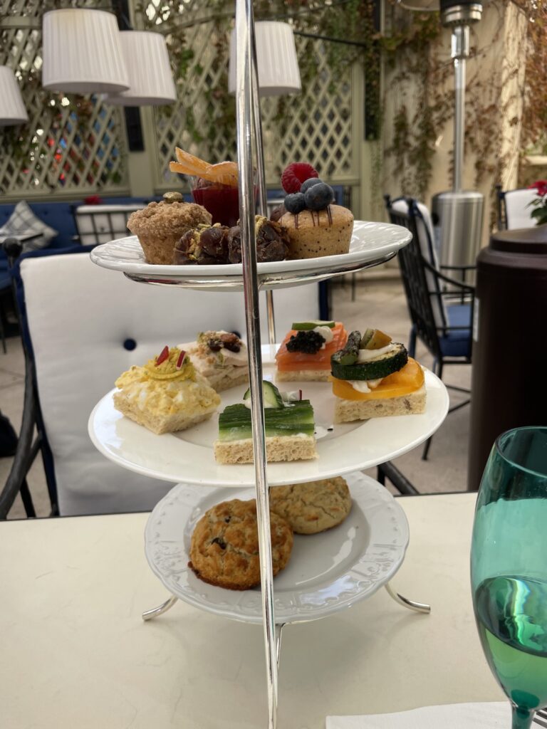 Holiday afternoon tea with a tiered stand of sandwiches and scones