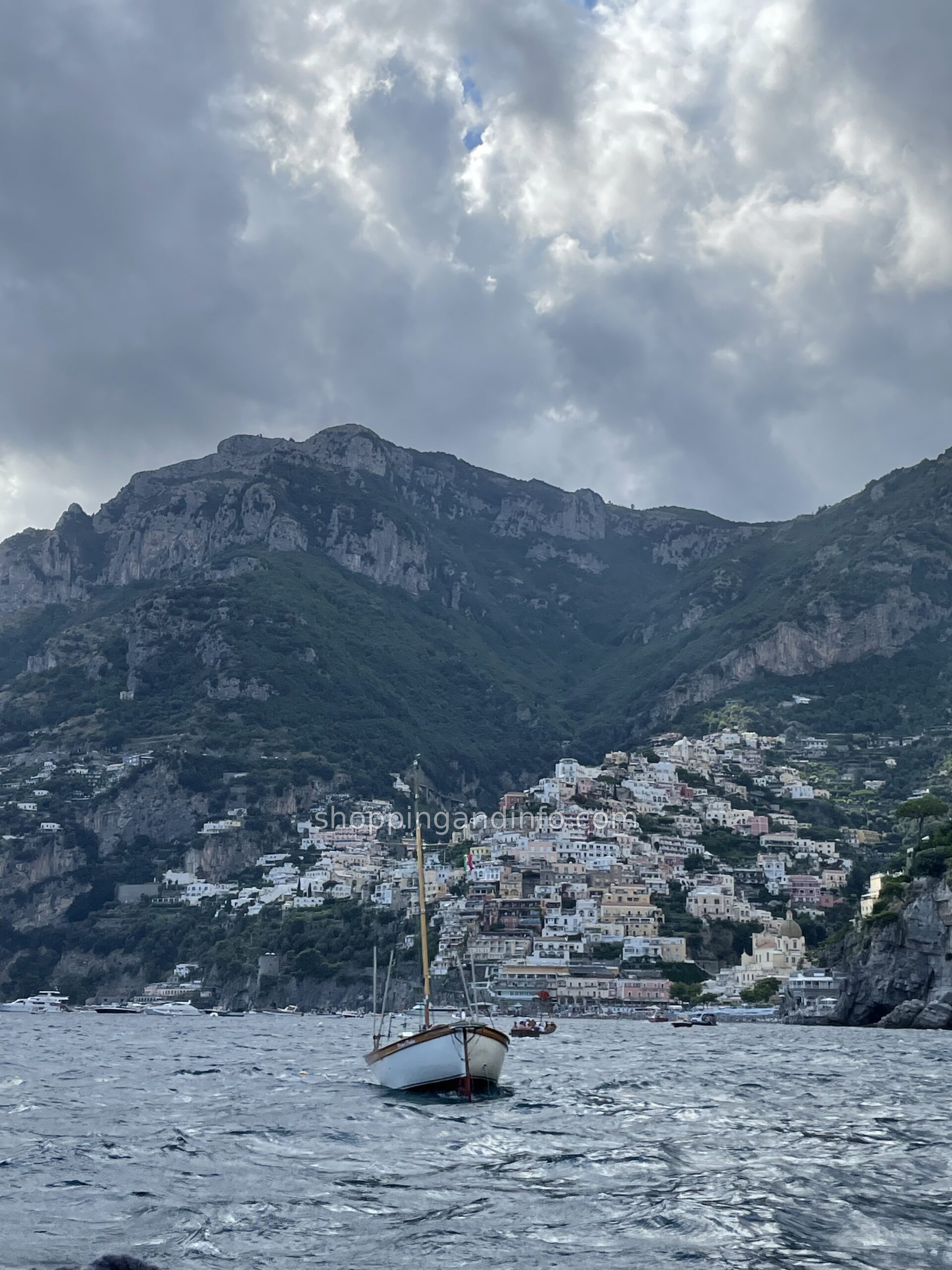 Positano seen from the water with a small wooden boat in the foreground