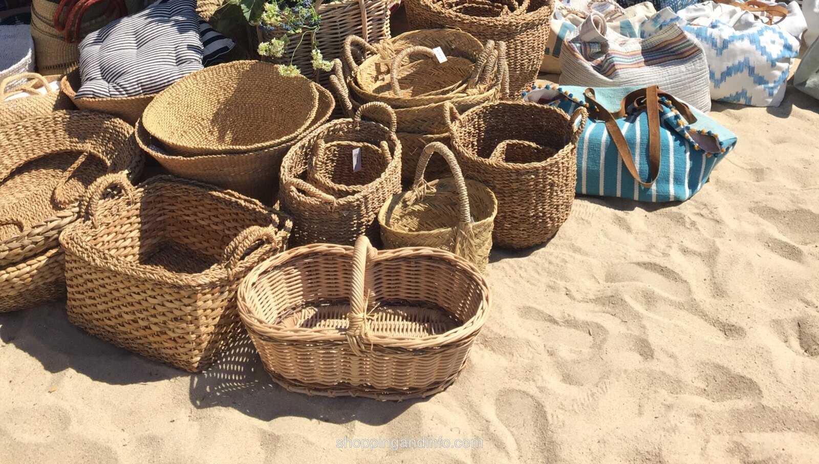 Woven market baskets on the sand at the Le Club 55 boutique in Saint-Tropez
