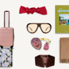 gifts for the woman who has everything - BEIS pink carry-on, Jennifer Behr red headwrap, Assouline Splendido book, Le Specs sunglasses, Swarovski pink ring, Quince cashmere throw, Rifle Paper Co floral notebook, Drowsy silk sleep mask flat lay collage