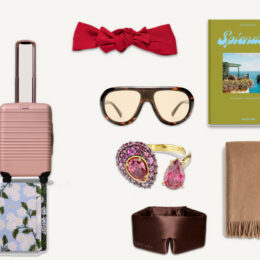 gifts for the woman who has everything - BEIS pink carry-on, Jennifer Behr red headwrap, Assouline Splendido book, Le Specs sunglasses, Swarovski pink ring, Quince cashmere throw, Rifle Paper Co floral notebook, Drowsy silk sleep mask flat lay collage
